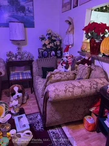 a bed with a pink blanket and pillows