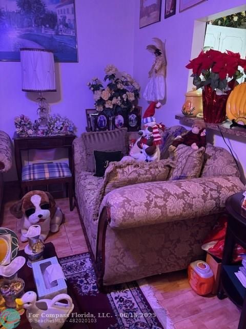 183 Camden H, Unit 183 West Palm Beach, FL 33417 - Photo 3 of 9 a bed with a pink blanket and pillows