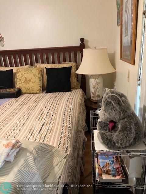 183 Camden H, Unit 183 West Palm Beach, FL 33417 - Photo 9 of 9 a bedroom with a bed and a window