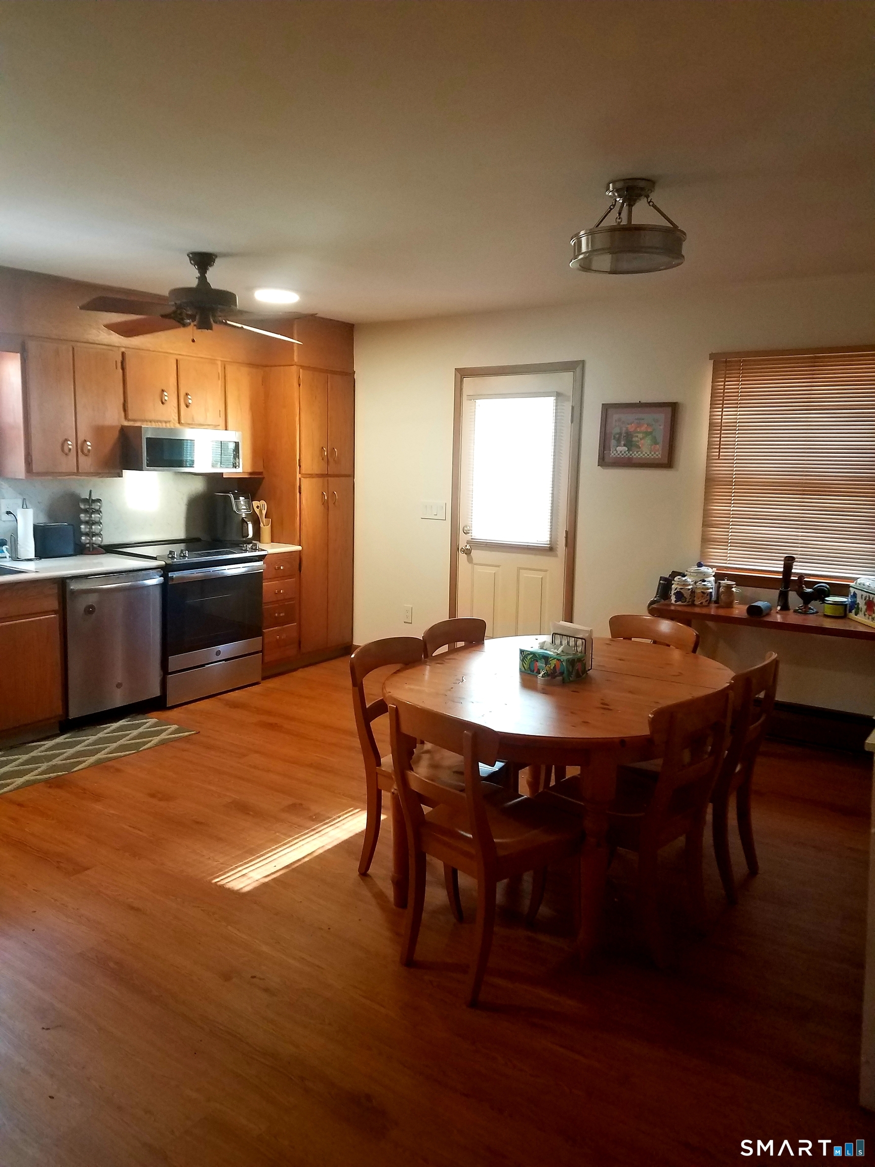 72 Maple Tree Avenue, Unit 2 Stamford, CT 06906 - Photo 25 of 25 a kitchen with stainless steel appliances granite countertop a stove a sink dishwasher a dining table and chairs with wooden floor