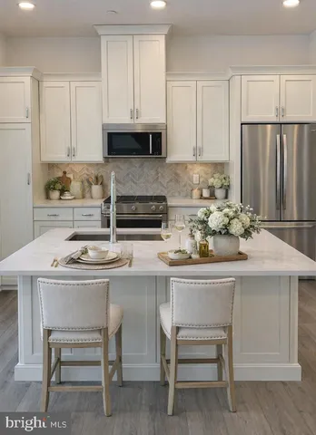 a kitchen with a sink cabinets and wooden floor