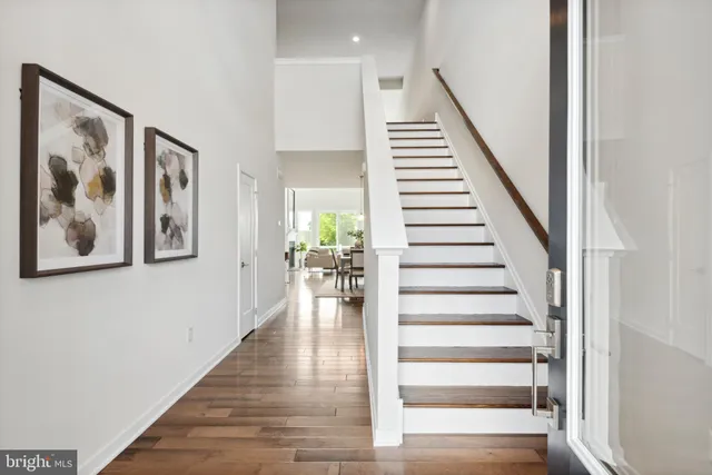 a view of entryway and hall with wooden floor