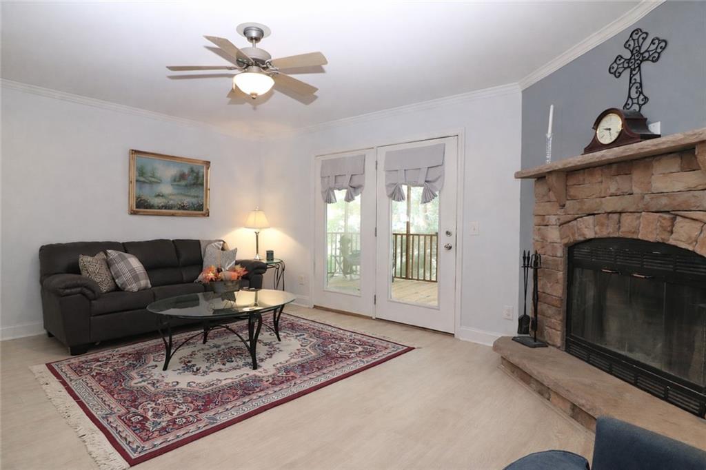 4650 Perry Road Gainesville, GA 30506 - Photo 13 of 41 a living room with furniture a fireplace and a table