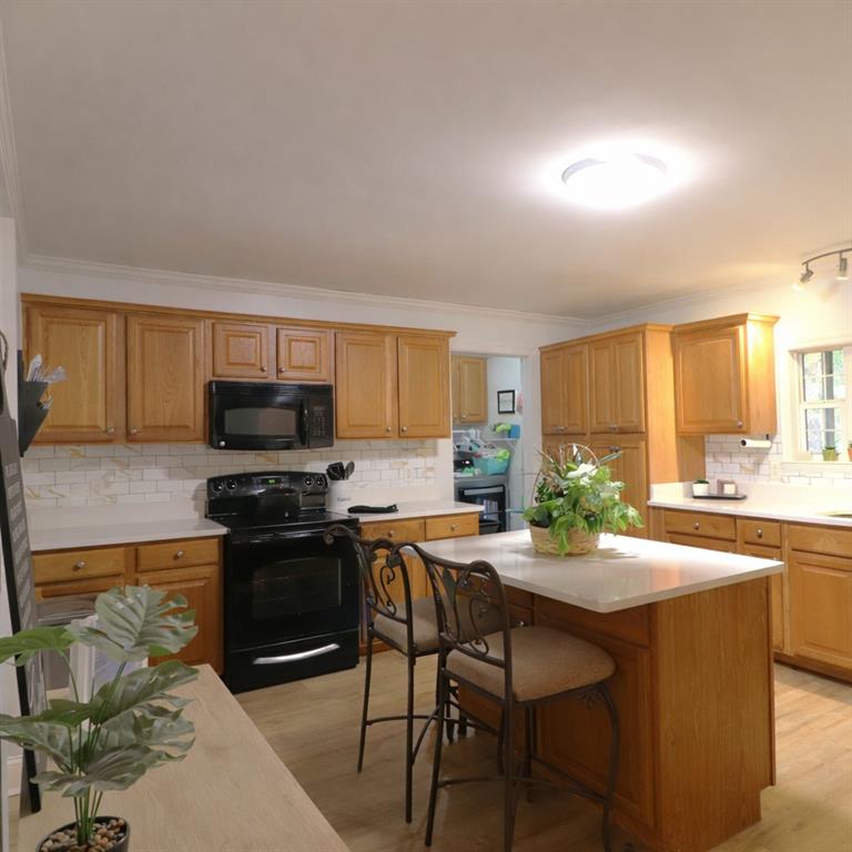 4650 Perry Road Gainesville, GA 30506 - Photo 15 of 41 a kitchen with stainless steel appliances granite countertop a stove top oven a sink a stove a dining table and chairs