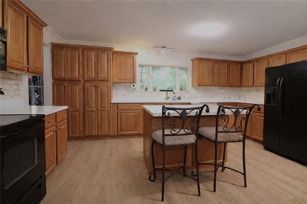 4650 Perry Road Gainesville, GA 30506 - Photo 16 of 41 a kitchen with stainless steel appliances granite countertop a dining table chairs refrigerator and sink