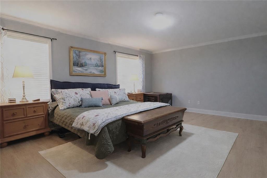 4650 Perry Road Gainesville, GA 30506 - Photo 19 of 41 a spacious bedroom with a bed and a desk