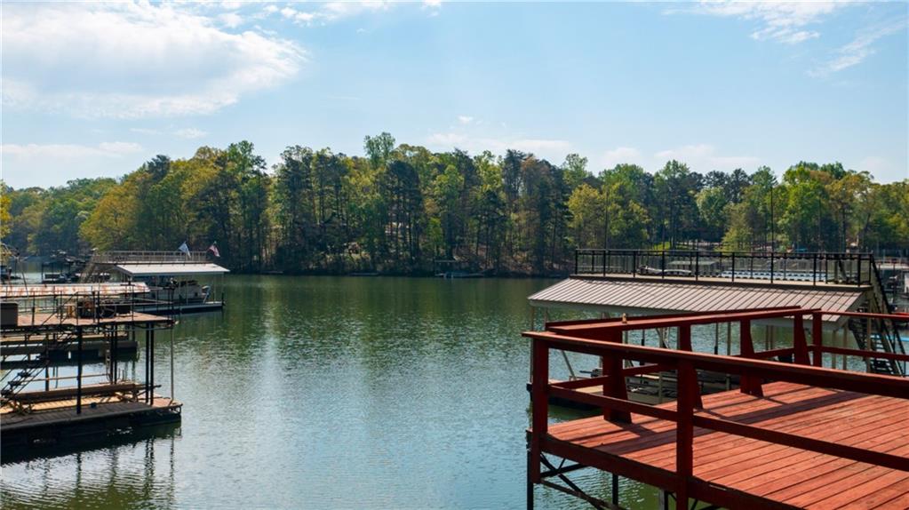 4650 Perry Road Gainesville, GA 30506 - Photo 33 of 41 a view of a roof deck with table and chairs a barbeque with wooden floor and fence