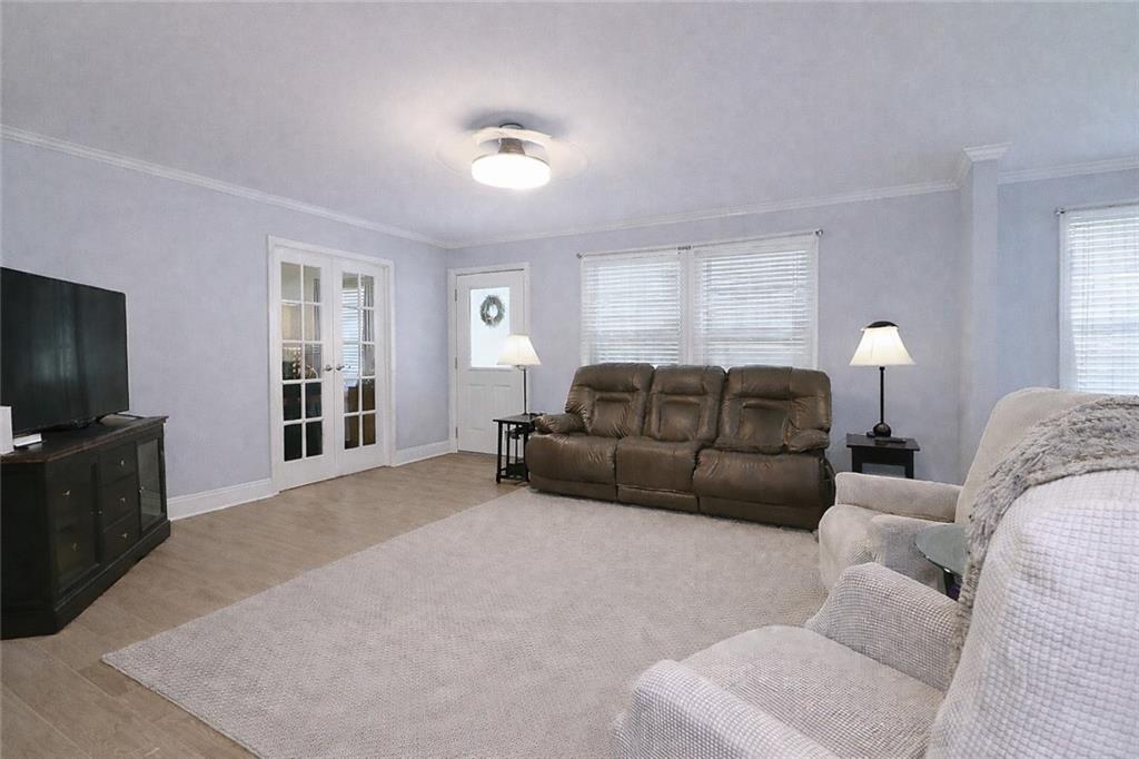 4650 Perry Road Gainesville, GA 30506 - Photo 6 of 41 a living room with furniture a flat screen tv and windows