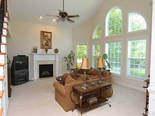 10537 Swerling Way Raleigh, NC 27614 - Photo 6 of 12 Wonderful family room - perfect for entertaining or relaxing - with gas log fireplace, soaring ceiling, and wall of Palladium windows. Den/Family/Great Room