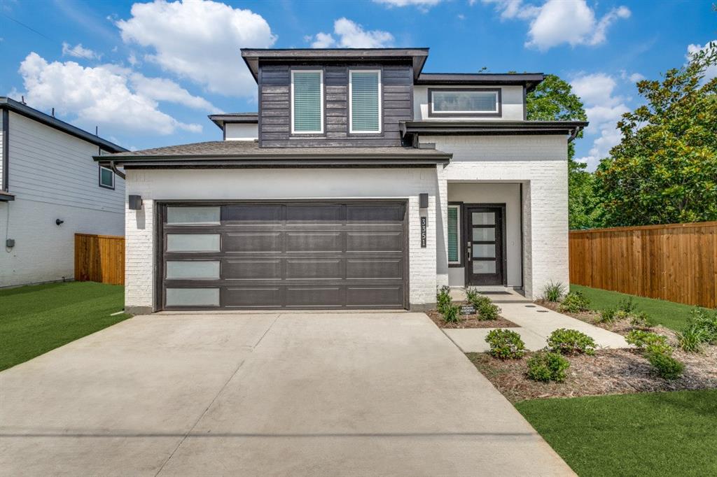 a front view of a house with a garden and garage