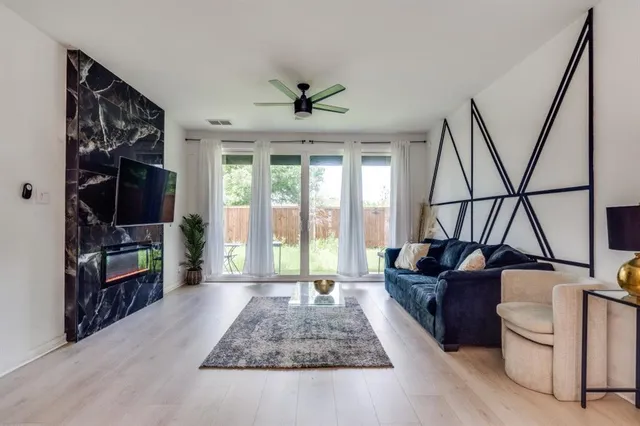 a living room with furniture and a floor to ceiling window