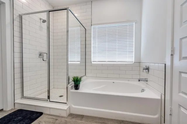 a bathroom with a bathtub and shower