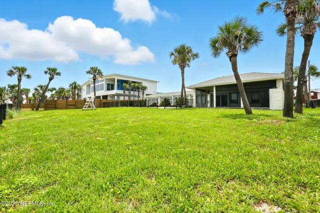 a view of a house with a yard and potted plants