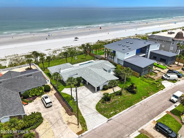 an aerial view of multiple houses with yard