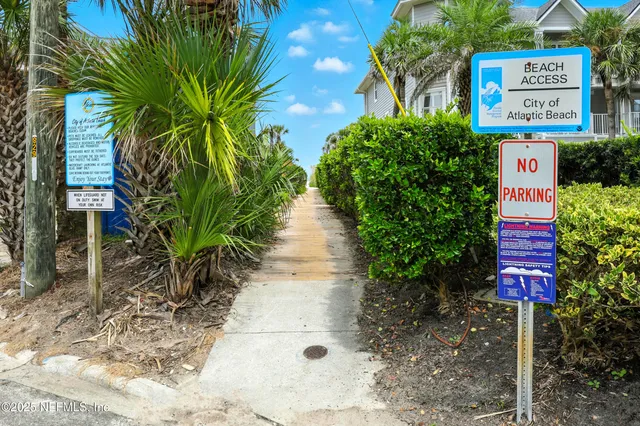 a sign of golf club on a wall under a tree
