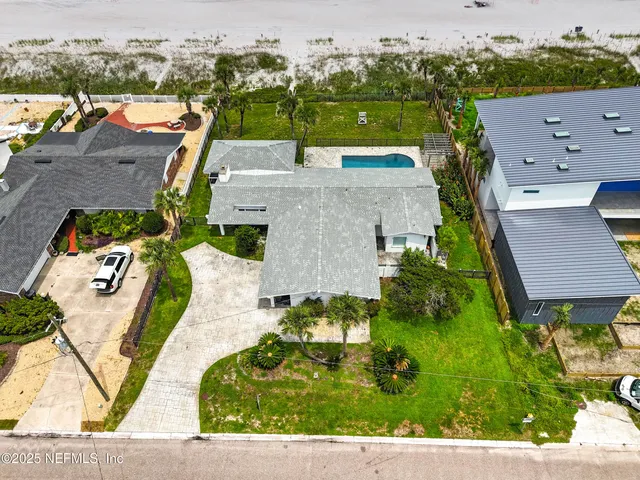 an aerial view of a house with a yard basket ball court and outdoor seating