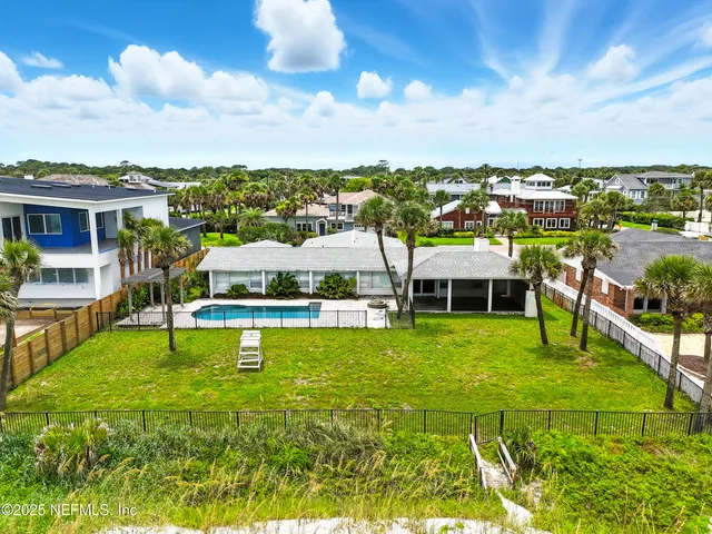 a swimming pool with outdoor seating and yard