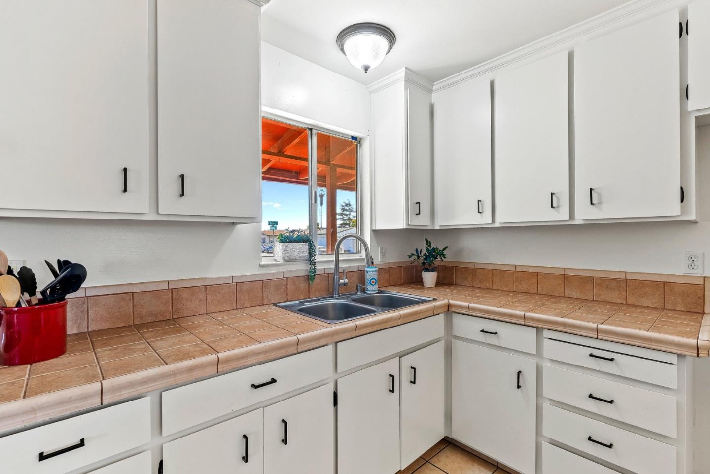1607 Chico Way Salinas, CA 93906 - Photo 28 of 32 a kitchen with stainless steel appliances granite countertop white cabinets sink and dishwasher