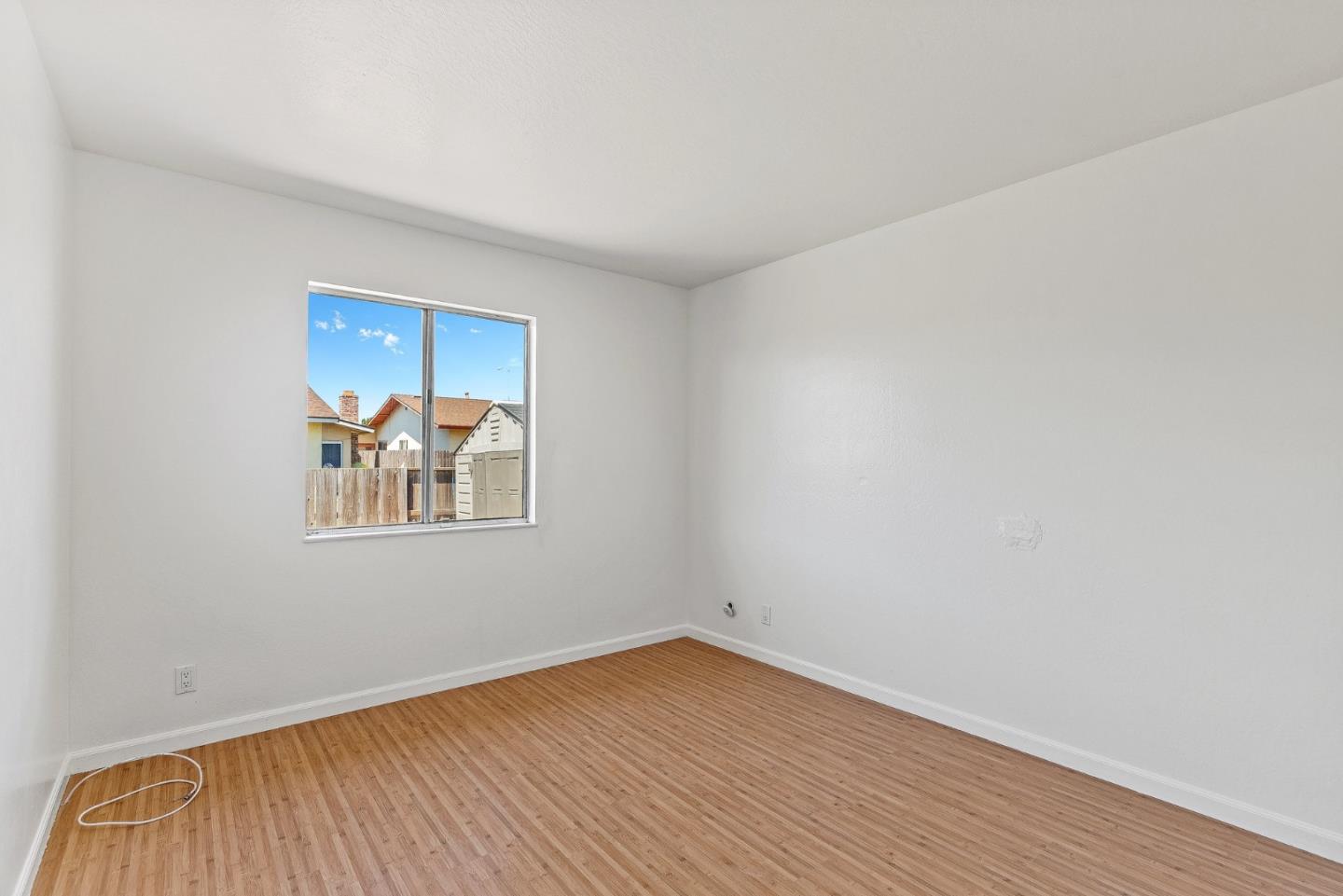 1607 Chico Way Salinas, CA 93906 - Photo 8 of 32 an empty room with wooden floor and windows