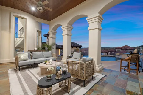 a living room with fireplace furniture and a floor to ceiling window