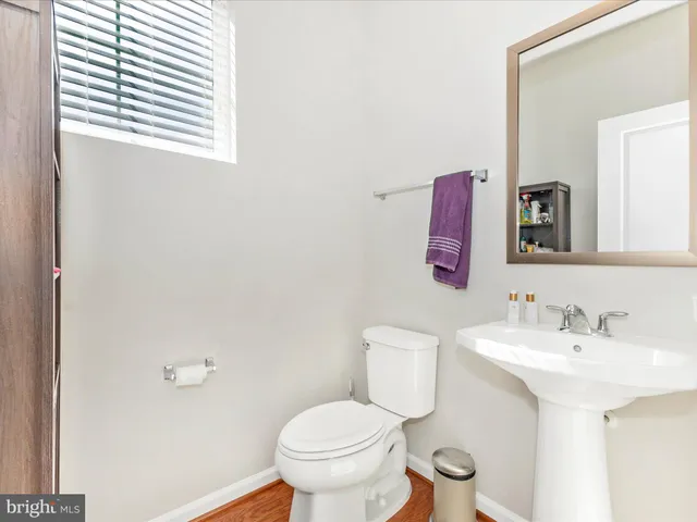 a bathroom with a sink toilet and mirror