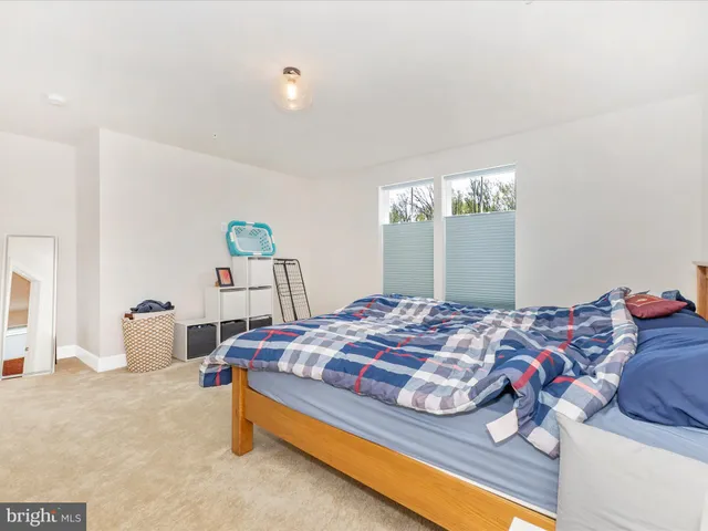 a bedroom with bed and window