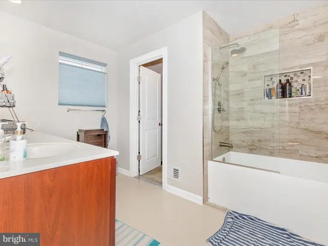 a bathroom with a sink a mirror and a bathtub