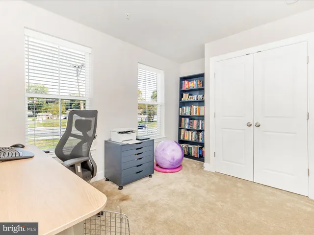 a view of a room with workspace and a window