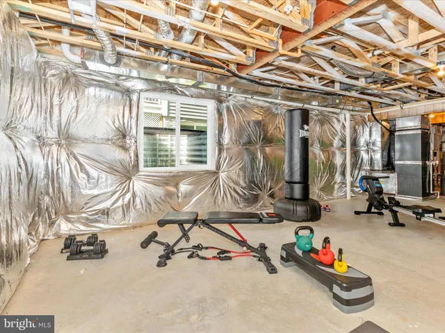 a room with gym equipment and a large mirror