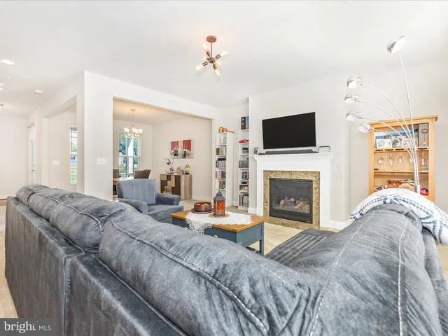 a living room with fireplace furniture and a flat screen tv