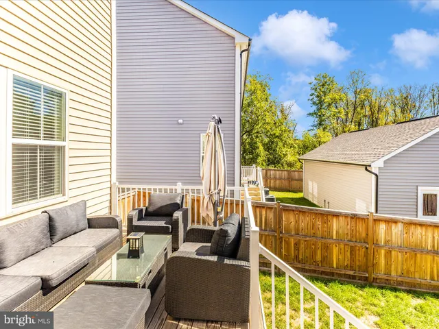a balcony with furniture and a potted plant