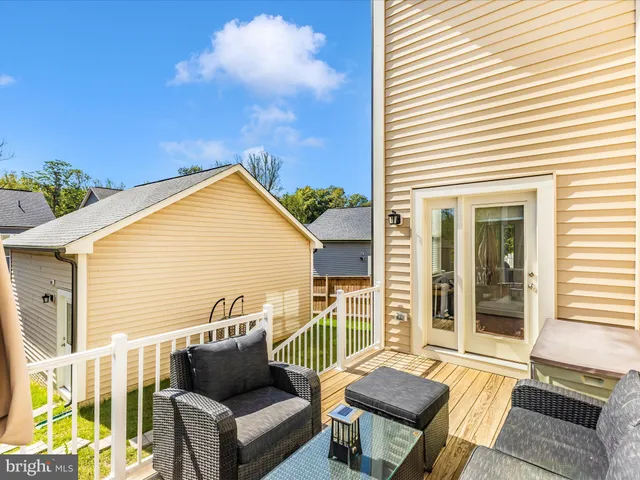 a balcony with furniture and a potted plant