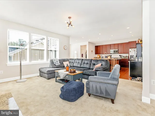 a living room with fireplace furniture and a large window