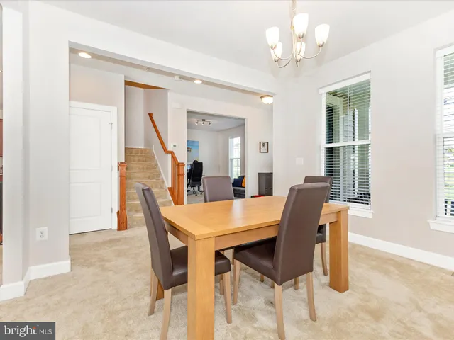 a view of a dining room with furniture and a chandelier