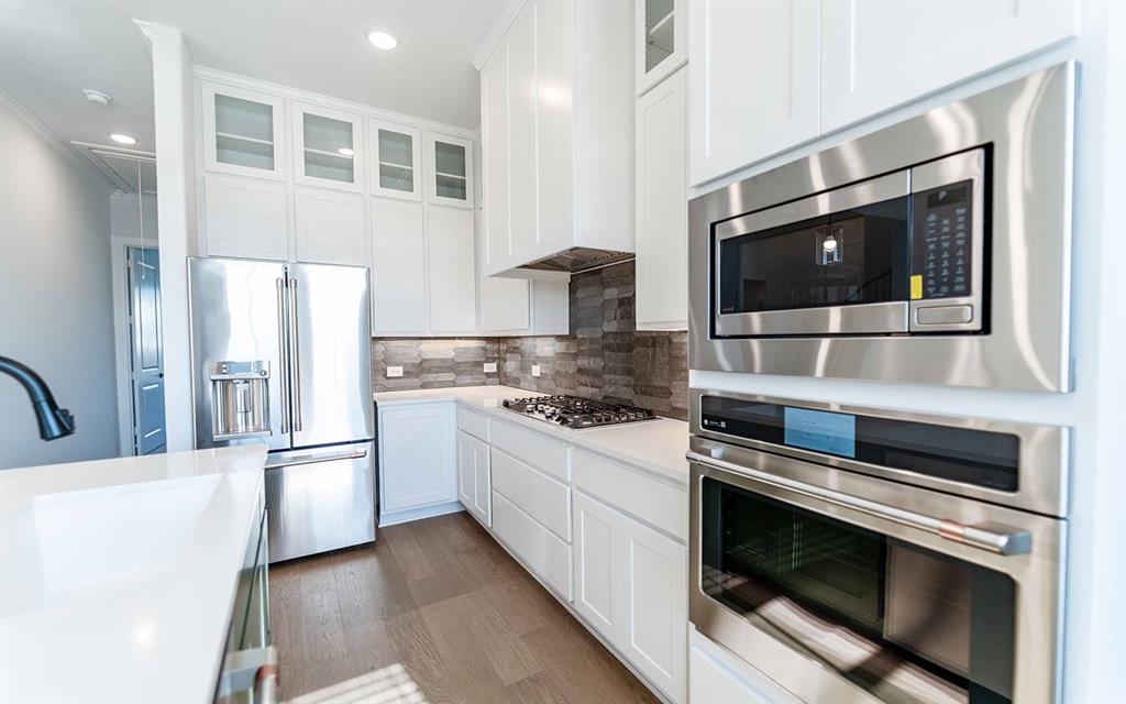 1924 Casting Ridge Mesquite, TX 75181 - Photo 11 of 30 a kitchen with stainless steel appliances kitchen island granite countertop a stove and a microwave