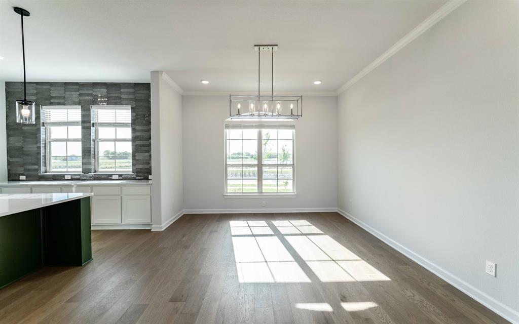 1924 Casting Ridge Mesquite, TX 75181 - Photo 12 of 30 a view of an empty room with wooden floor and a window
