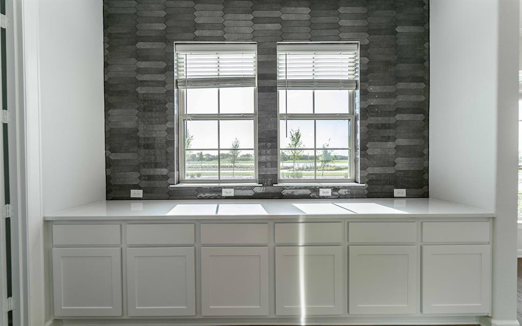 1924 Casting Ridge Mesquite, TX 75181 - Photo 13 of 30 a view of a kitchen with granite countertop white cabinets and a sink