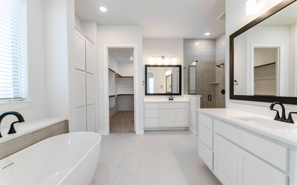 1924 Casting Ridge Mesquite, TX 75181 - Photo 15 of 30 a large white bathroom with a double vanity sink a mirror and a shower