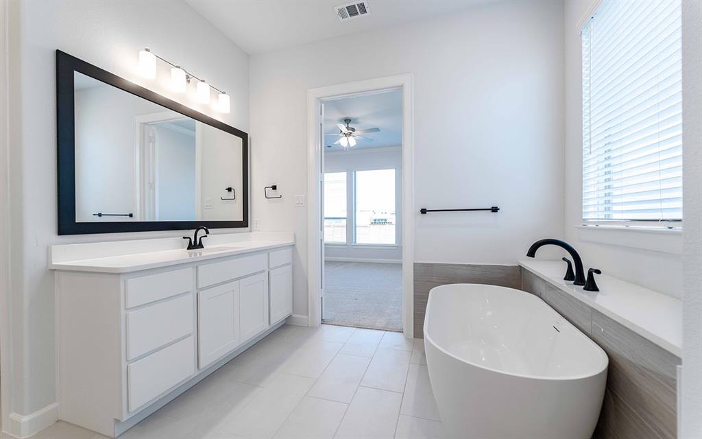 1924 Casting Ridge Mesquite, TX 75181 - Photo 18 of 30 a bathroom with a double vanity sink and a bathtub