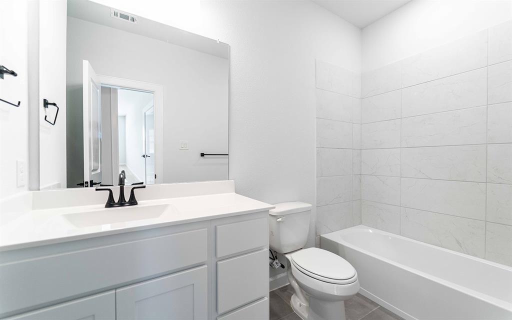 1924 Casting Ridge Mesquite, TX 75181 - Photo 21 of 30 a bathroom with a sink a toilet and a bathtub