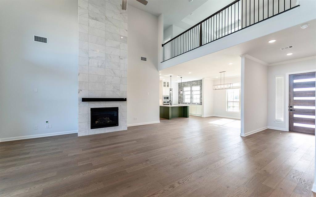 1924 Casting Ridge Mesquite, TX 75181 - Photo 3 of 30 an empty room with wooden floor fireplace and windows