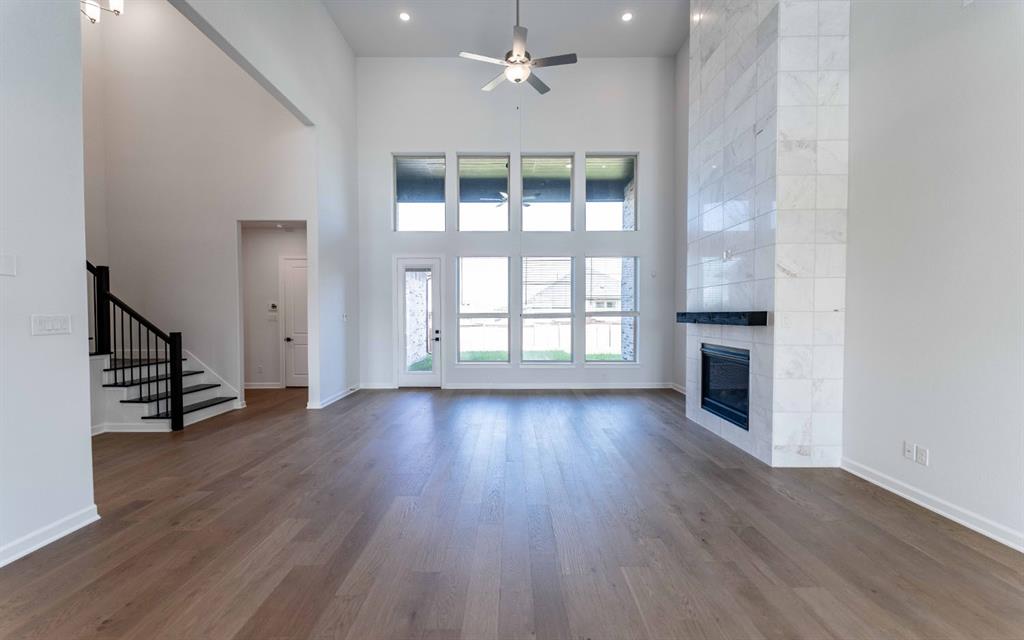 1924 Casting Ridge Mesquite, TX 75181 - Photo 5 of 30 an empty room with wooden floor fireplace and windows