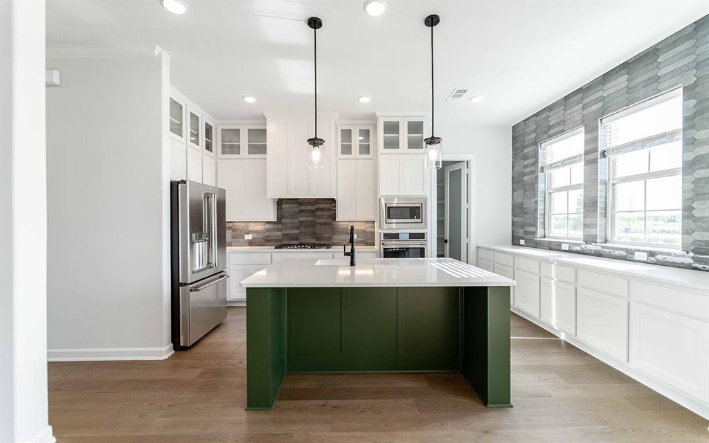 1924 Casting Ridge Mesquite, TX 75181 - Photo 8 of 30 a kitchen with stainless steel appliances kitchen island granite countertop a sink refrigerator and cabinets