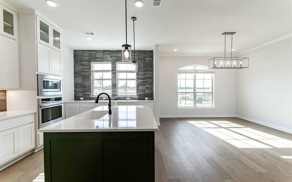 1924 Casting Ridge Mesquite, TX 75181 - Photo 9 of 30 a kitchen with kitchen island granite countertop a sink window and stainless steel appliances