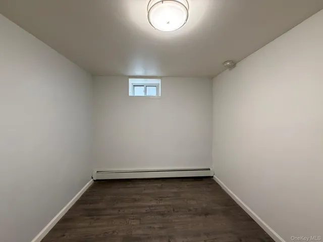 a view of a room with wooden floor and window