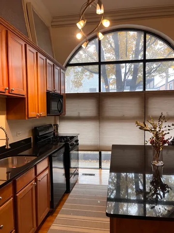 a kitchen with stainless steel appliances a stove sink and cabinets