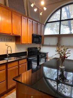 a kitchen with sink refrigerator and cabinets