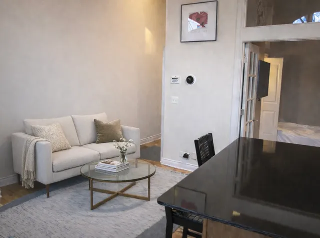 a view of a livingroom with furniture and a window