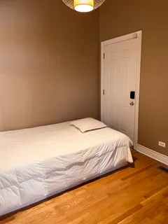 a bedroom with a bed and a night stand