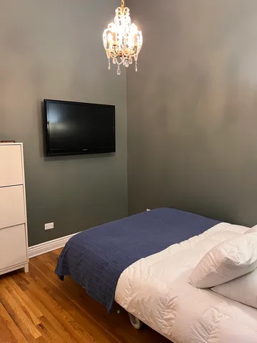 a bedroom with a bed and a flat screen tv